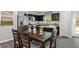 Inviting dining area adjacent to the kitchen features a stylish table set and view of stainless appliances at 1537 Ivy Meadow Ln, Zebulon, NC 27597