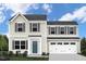 Charming two-story home featuring a two-car garage, neutral siding, and complemented by dark shutters at 1537 Ivy Meadow Ln, Zebulon, NC 27597