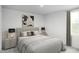 Cozy bedroom featuring neutral tones, a large window, and stylish bedside lamps at 1541 Ivy Meadow Ln, Zebulon, NC 27597