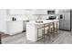 Bright kitchen featuring white cabinets, quartz countertops, stainless steel appliances, and a breakfast bar with seating at 1541 Ivy Meadow Ln, Zebulon, NC 27597