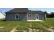 The backyard features a patio and a lush green lawn area, with gray siding at 166 Coharie Dr, Lillington, NC 27546