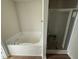 Bathroom features a soaking tub and a separate tiled shower with glass door at 166 Coharie Dr, Lillington, NC 27546