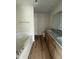 Bathroom with a double vanity, granite counters, wood look flooring, and soaking tub at 166 Coharie Dr, Lillington, NC 27546