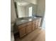 Bathroom with a double vanity, granite counters, wood look flooring, and large mirror at 166 Coharie Dr, Lillington, NC 27546