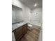Well-lit bathroom featuring granite countertops, wood cabinets, and a shower-tub combination at 166 Coharie Dr, Lillington, NC 27546
