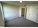 Spacious bedroom featuring plush carpet, neutral walls, and ample closet space at 166 Coharie Dr, Lillington, NC 27546