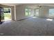 Bright, open living room with plush carpet, neutral walls, and large windows allowing natural light at 166 Coharie Dr, Lillington, NC 27546
