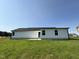 Home's backyard featuring a patio, lush lawn, and well-maintained white siding at 179 Coharie Dr, Lillington, NC 27546