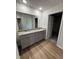 Bright bathroom featuring a double vanity with granite countertops, undermount sinks and gray cabinetry at 179 Coharie Dr, Lillington, NC 27546