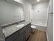 Modern bathroom showcasing a single vanity with granite countertops, and shower-tub combo at 179 Coharie Dr, Lillington, NC 27546