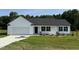 Charming single-story home featuring a classic white facade, a two-car garage, and a neatly maintained lawn at 179 Coharie Dr, Lillington, NC 27546