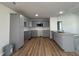 Modern kitchen with gray cabinets, granite countertops, stainless steel appliances, and wood-look flooring at 179 Coharie Dr, Lillington, NC 27546