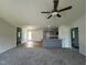 Spacious living room flows into the kitchen, with a breakfast bar and gray cabinets at 179 Coharie Dr, Lillington, NC 27546