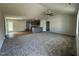 Open-concept layout showcasing the living room, wood-look floors, and gray kitchen with a breakfast bar at 179 Coharie Dr, Lillington, NC 27546