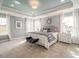 Serene main bedroom featuring a tray ceiling, plush carpeting, and soft natural light at 2014 Cross Bones Blvd # 30, Durham, NC 27703
