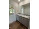 Bathroom with double vanity featuring granite countertops, modern fixtures, and ample cabinet space at 206 Coharie Dr, Lillington, NC 27546