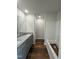 Bathroom features double vanity with granite countertops, wood look flooring, and shower at 206 Coharie Dr, Lillington, NC 27546