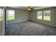 Bright bedroom features plush carpeting, ceiling fan, and large windows with scenic views at 206 Coharie Dr, Lillington, NC 27546