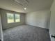 Bedroom featuring plush carpeting, a bright window, and neutral paint tones at 206 Coharie Dr, Lillington, NC 27546