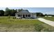 Charming single-story home with a well-manicured lawn and a covered front porch at 206 Coharie Dr, Lillington, NC 27546