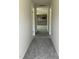 Hallway view leading into the spacious open-concept kitchen with modern appliances at 206 Coharie Dr, Lillington, NC 27546