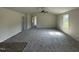 Bright living room featuring neutral walls, new carpet, and a ceiling fan for added comfort at 206 Coharie Dr, Lillington, NC 27546