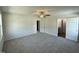Spacious main bedroom with plush carpeting, ceiling fan, and ensuite bathroom access at 206 Coharie Dr, Lillington, NC 27546