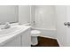 A full bathroom is shown with neutral walls, wood-look flooring, and white fixtures at 216 E Hinton St, Clayton, NC 27520