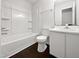 Spotless bathroom with a combination tub and shower, white vanity, and a sleek modern look at 216 E Hinton St, Clayton, NC 27520