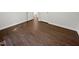 A bedroom is shown with wood-look flooring, neutral walls, and white trim at 216 E Hinton St, Clayton, NC 27520