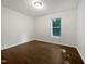 A bedroom is shown with wood-look floors, neutral walls, white trim, and a window at 216 E Hinton St, Clayton, NC 27520