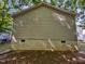 An exterior shot of a home with tan siding and a cement foundation at 216 E Hinton St, Clayton, NC 27520