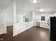 Spacious open-concept kitchen flowing into living area with white cabinets and modern stainless steel appliances at 216 E Hinton St, Clayton, NC 27520