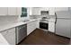 Bright kitchen featuring white cabinets, modern appliances, and marble-look countertops at 216 E Hinton St, Clayton, NC 27520