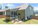 Image of a backyard featuring an outdoor patio with a grill, fire pit, seating, and screened-in porch at 240 Paddy Ln, Youngsville, NC 27596