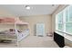 This bedroom features a bunkbed set and a large window at 240 Paddy Ln, Youngsville, NC 27596