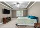 Comfortable bedroom with large window, tray ceiling, and built-in fireplace at 240 Paddy Ln, Youngsville, NC 27596