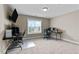 The bedroom features neutral carpeting, a ceiling fan, and a big window at 240 Paddy Ln, Youngsville, NC 27596