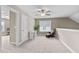 Bright bonus room with neutral carpeting, a ceiling fan, desk and comfortable chair at 240 Paddy Ln, Youngsville, NC 27596
