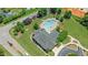 Aerial view showcasing the neighborhood community pool surrounded by a deck, trees, and pool furniture at 240 Paddy Ln, Youngsville, NC 27596