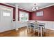 Dining room with hardwood floors, white trim and wainscotting, and a window with natural light at 240 Paddy Ln, Youngsville, NC 27596