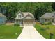 Charming two-story home featuring a two-car garage, well-manicured lawn, and inviting curb appeal at 240 Paddy Ln, Youngsville, NC 27596
