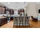 Stylish kitchen with stainless steel appliances, dark cabinets, and granite countertops at 240 Paddy Ln, Youngsville, NC 27596