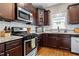 Close up on the kitchen with stainless steel appliances and granite countertops at 240 Paddy Ln, Youngsville, NC 27596