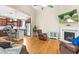 Open-concept living room featuring a fireplace, hardwood floors, and view into kitchen at 240 Paddy Ln, Youngsville, NC 27596
