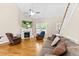 Cozy living room with a fireplace, ceiling fan, and lots of natural light at 240 Paddy Ln, Youngsville, NC 27596