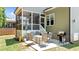 Back patio with a table and chairs next to a grill at 240 Paddy Ln, Youngsville, NC 27596