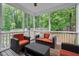 Cozy covered patio with orange cushioned chairs for outdoor entertaining at 240 Paddy Ln, Youngsville, NC 27596