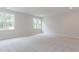 Bright bedroom featuring plush carpet, neutral paint and great natural light from two large windows at 25 Alex Farm Ct, Zebulon, NC 27597