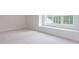 Bedroom with plush carpet, white trim, and a large window with a built-in bench seat at 25 Alex Farm Ct, Zebulon, NC 27597